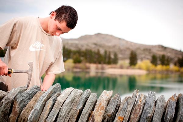 Nikora Parsons works on a wall in old Cromwell last week. (picture by: Isabella Harrex)